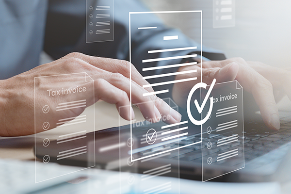 An image showing a laptop user working on a tax submission