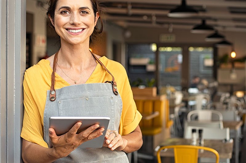 Rosie_cafe-owner - CHL Mortgages for Intermediaries A photo of a smiling female cafe owner