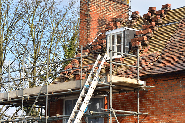 A house with scaffolding undergoing roof repair