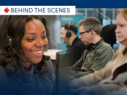 Behind the scenes: smiling call center agents wearing headsets at their desks