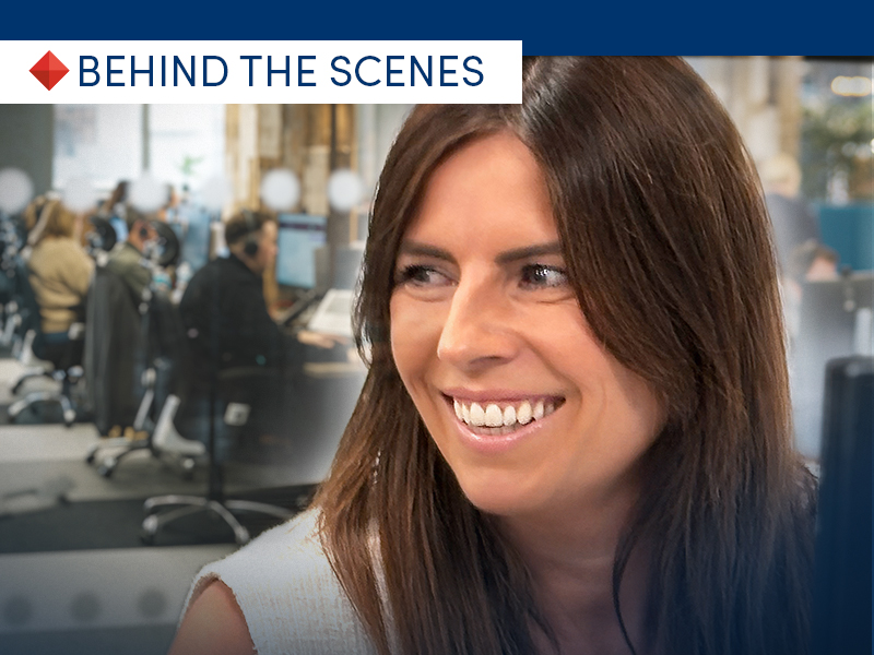 A photo of Vic Sharples, CHL Mortgages Head of Secured Lending smiling, with lending team at work in the background.
