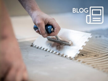 Blog-Refurb-Launch-2026 - CHL Mortgages for Intermediaries Person uses a notched trowel to spread thinset mortar on a tile for installation (tiling).