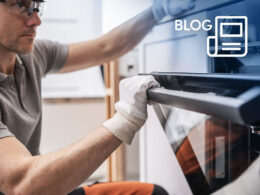 A kitchen fitter inspecting a new oven