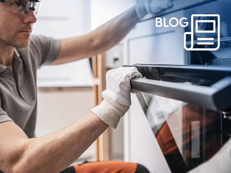 A kitchen fitter inspecting a new oven